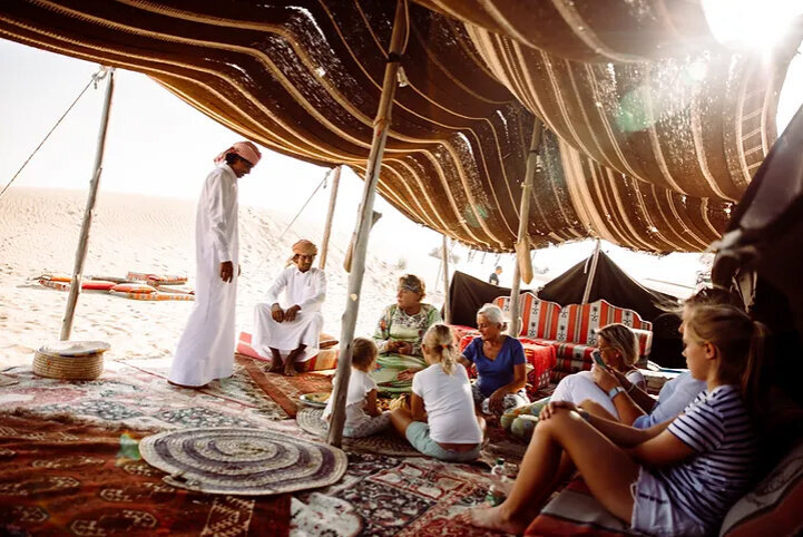 Guests gathered inside a Bedouin tent in the desert