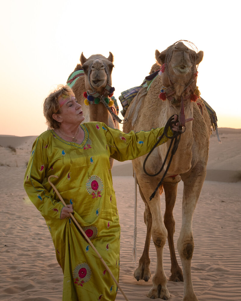 Uschi walking with her camels across the desert