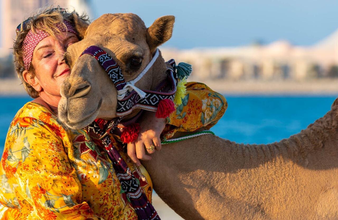 Uschi embracing a decorated camel